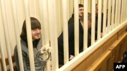 Suspects in the murder trial of journalist Anna Politkovskaya sit in the defendants' cage in a Moscow court.