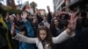 Students held up their hands to protest what they regarded as police violence during an antigovernment protest in downtown Sofia on November 13. 