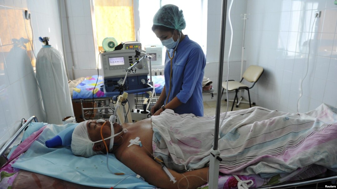 A nurse on December 19 attends to a man injured during the clashes in the city of Zhanaozen three days earlier.