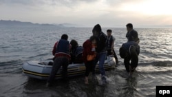 Afghan migrants disembark on a beach on the Greek island of Kos after crossing the strait from Turkey, in May.