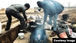 Images like this of homeless people living in graves have sparked outrage in Iran.