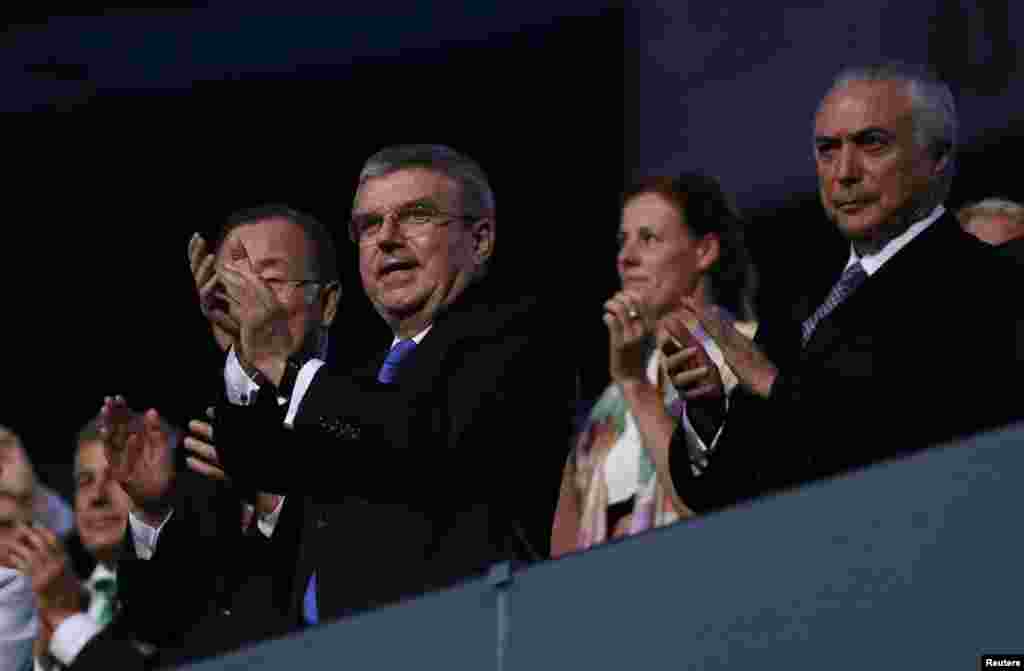 The president of the International Olympic Committee, Thomas Bach (center), and Brazil's interim president, Michel Temer, watch the festivities.