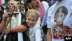 Yulia Tymoshenko greets her supporters during a rally in front of Kyiv district court on June 24.