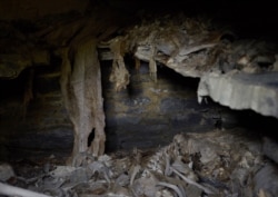 A stone shelf and human remains inside the huts, around half a kilometer from Georgia’s border with the Russian republic of Chechnya.