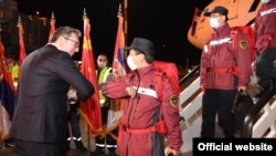 Președintele Aleksandar Vucic (fără mască) întâmpină experții chinezi în domeniul sănătății care au adus la Belgrad materiale sanitare după declanșarea pandemiei de COVID-19. (21 martie 2020)