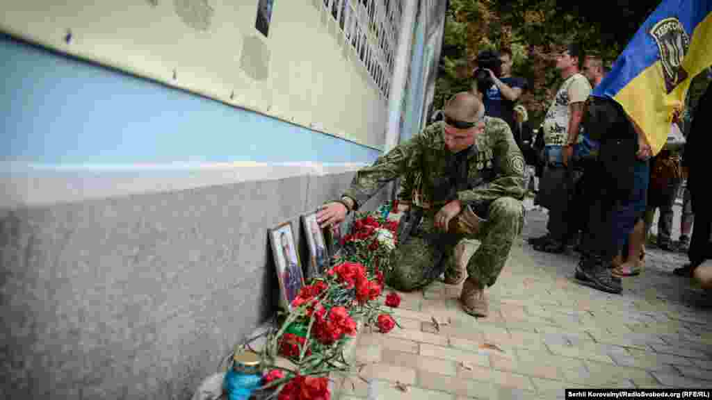 Боєць батальйону «Донбас» схилився над фотографією товариша, якого він втратив в «Іловайському котлі»