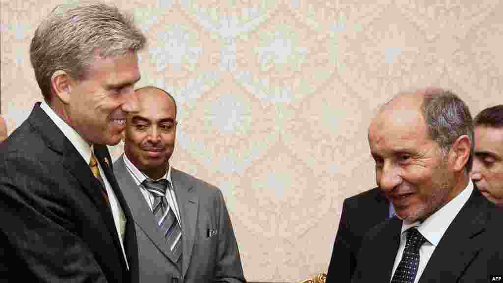 Libya's National Transitional Council chairman Mustafa Abdel Jalil (right) meets with U.S. Ambassador to Libya Chris Stevens (left) in Tripoli on June 7. Stevens was killed in the violence.