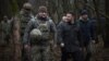 Ukrainian President Volodymyr Zelenskiy (second right) visits a division of the 27th Rocket Artillery Brigade on December 12. 
