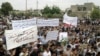 Antiregime protesters carry banners during a rally in Talbiseh, in the central Syrian province of Homs, last month.