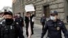 Russian police detain a protester holding a placard that says "Journalism is not a crime." (file photo)