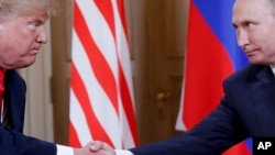 Donald Trump shakes hands with Russian President Vladimir Putin during a meeting in Helsinki in 2018.