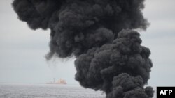 Oil burns during a controlled fire in the Gulf of Mexico