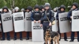 Kazakhstan - Shymkent - mother Laura KalyRiot police officers keep watch on opposition supporters during a rally - Kazakhstan protest in Nur-Sultan on June 9, 2019 - the day of Kazakhstan's presidential elections. (Photo by VYACHESLAV OSELEDKO / AFP)