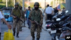 Indian paramilitary soldiers patrol as they guard at a busy market in Srinagar in Indian-administered Kashmir on April 29.