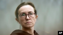 RFE/RL journalist Alsu Kurmasheva stands in a glass cage in a courtroom in Kazan, Russia, on February 1. She has been detained since October 2023.