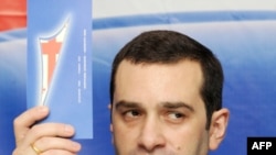 Irakli Alasania holds up a leaflet for his new party.