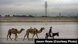 A transmission line across the Amu Darya River brings power from Uzbekistan into Afghanistan, which is dependent on its neighbors for much of its electricity. (file photo)