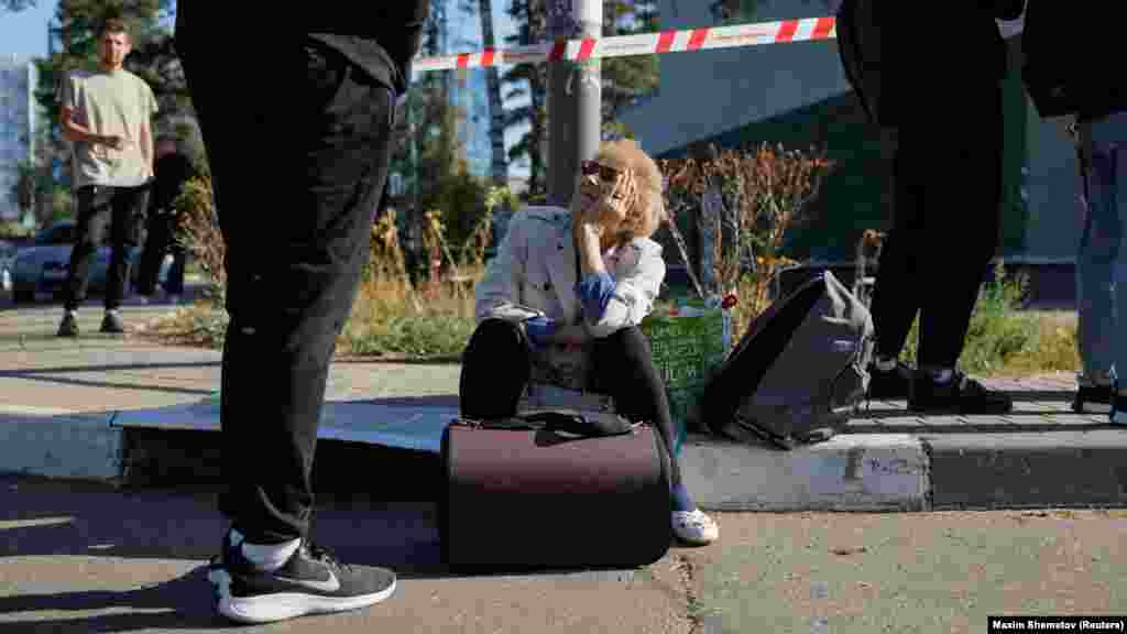 Local residents wait to return home as investigators assess the damage. Moscow's airports were disrupted for more than six hours, with nearly 50 flights diverted as a precautionary measure.