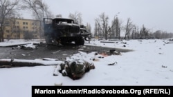 A body lies beside a destroyed Grad missile system near Kharkiv on February 25.