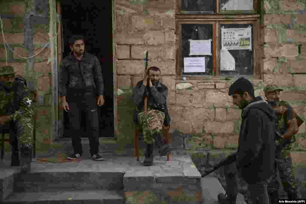 Ethnic Armenian gunmen rest in a village south of Stepanakert. In August 2020, just before the latest hostilities broke out, lawmaker Sasun Mikaelian called for a formal volunteer militia to be formed to supplement Armenia’s military. Mikaelian said such a militia was necessary because Armenia was “surrounded by enemies.” 