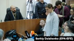 Yana Duhar (standing) appears in court in Kyiv on December 13.