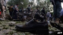 A victim's shoe lies on the ground as police secure the site of a suicide attack in Kabul in June.