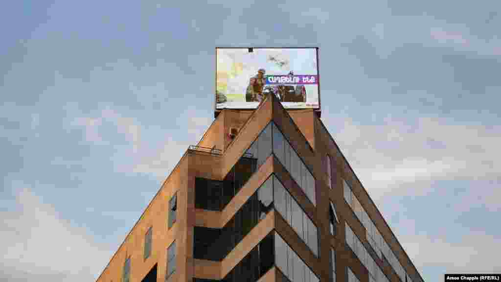 A photo of a now-deceased Armenian soldier is displayed on a building in central Yerevan on October 28. 