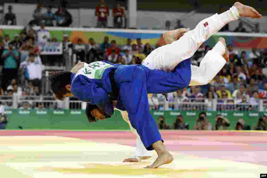 Russia's Beslan Mudranov (white) competes with Kazakhstan's Yeldos Smetov during their gold medal tie in the men's 60-kilogram judo contest, which was won by Mudranov.