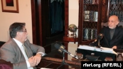 Afghan President Hamid Karzai (right) sits down with RFE/RL's Akbar Ayazi in Kabul on November 26.