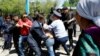 Полицейские и сотрудники специального подразделения задерживают собравшихся участвовать в «земельном» митинге. Алматы, 21 мая 2016 года.