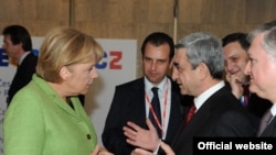German Chancellor Angela Merkel talks to Armenian President Serzh Sarkisian at the European Partnership summit in Prague in May 2009.