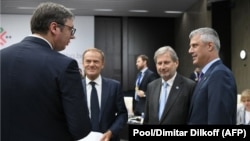 Serbian President Aleksander Vucic (left) speaks with Kosovar President Hashim Thaci (right) next to European Commissioner for European Neighborhood Policy Johannes Hahn (2nd right) and European Council President Donald Tusk during the EU-Western Balkans summit last month.