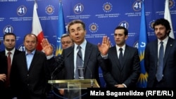Bidzina Ivanishvili (center) is seen presenting his cabinet picks in Tbilisi on October 8. A relative newcomer to politics, analysts suggest Ivanishvili must still tame the nine parties composing his Georgian Dream coalition.