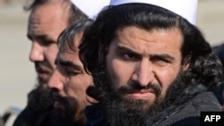 Freed Taliban prisoners sit on chairs as they listen to speeches during a ceremony to mark their release in Pul-e-Charkhi jail on the outskirts of Kabul on January 4.