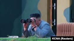 NORTH KOREA -- North Korean leader Kim Jong Un watches the test-fire of two short-range ballistic missiles at an undisclosed location, July 25, 2019