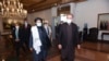 Pakistani Foreign Minister Shah Mehmood Qureshi (right) walks alongside Taliban co-founder Mullah Abdul Ghani Baradar upon the delegation's arrival for talks in Islamabad on December 16.