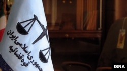 The flag of the Iranian Judiciary hangs in a court in Tehran