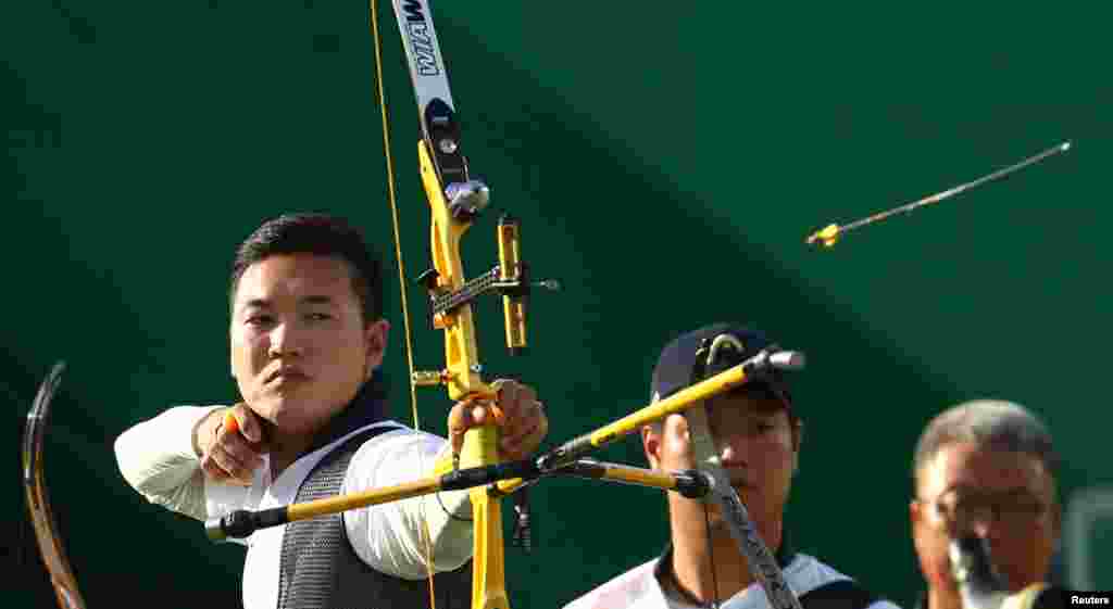 Members of the South Korean team compete in the men's archery semifinal. The Koreans eventually won gold in the men's team competition. 