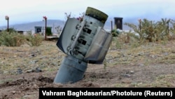 An unexploded rocket is seen near a graveyard in a town in Nagorno-Karabakh on October 1.