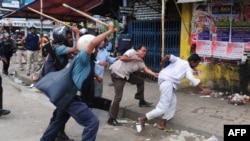 Bangladeshi police baton-charge Islamists during clashes in Dhaka on May 5. Opposition groups claim hundreds of Hefazat supporters have disappeared since.