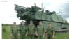 Російські солдати на тлі установки «Бук» – ілюстрація з розслідування Bellingcat