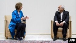 EU High Representative for Foreign Affairs Catherine Ashton (left) speaks with Iranian Foreign Minister Mohammad Javad Zarif at the start of two days of closed-door nuclear talks in Geneva.