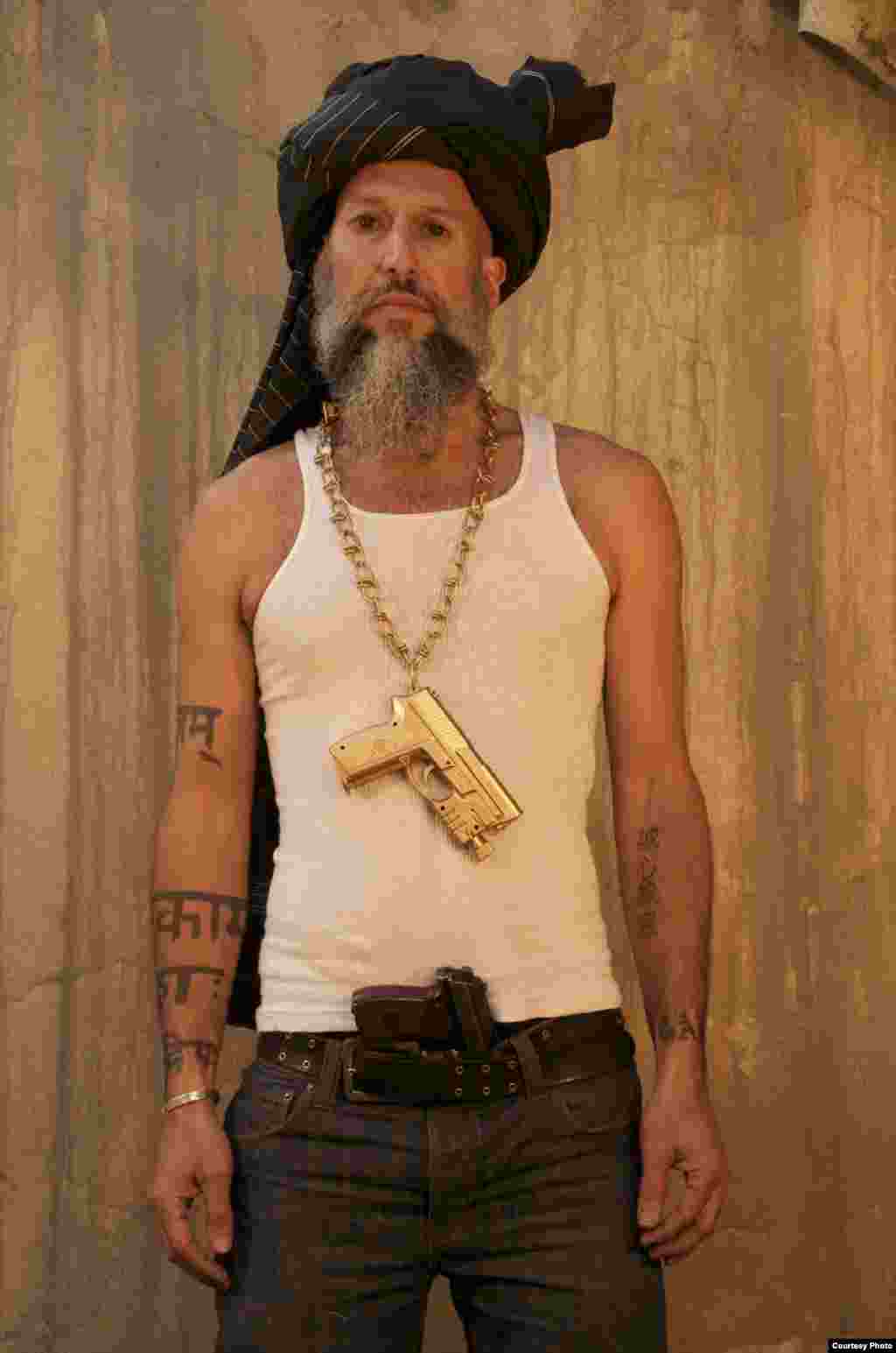 Aman Mojadidi poses as a "jihadi gangster" in this photo titled "Dressing for Work," part of the "A Day in the Life of a Jihadi Gangster" photo series.
