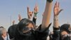 Iranian protesters shout slogans during an opposition rally at the cemetery 