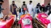 Afghan Sikh men prepare a funeral pyre for victims of a March attack on a Sikh temple in Kabul.