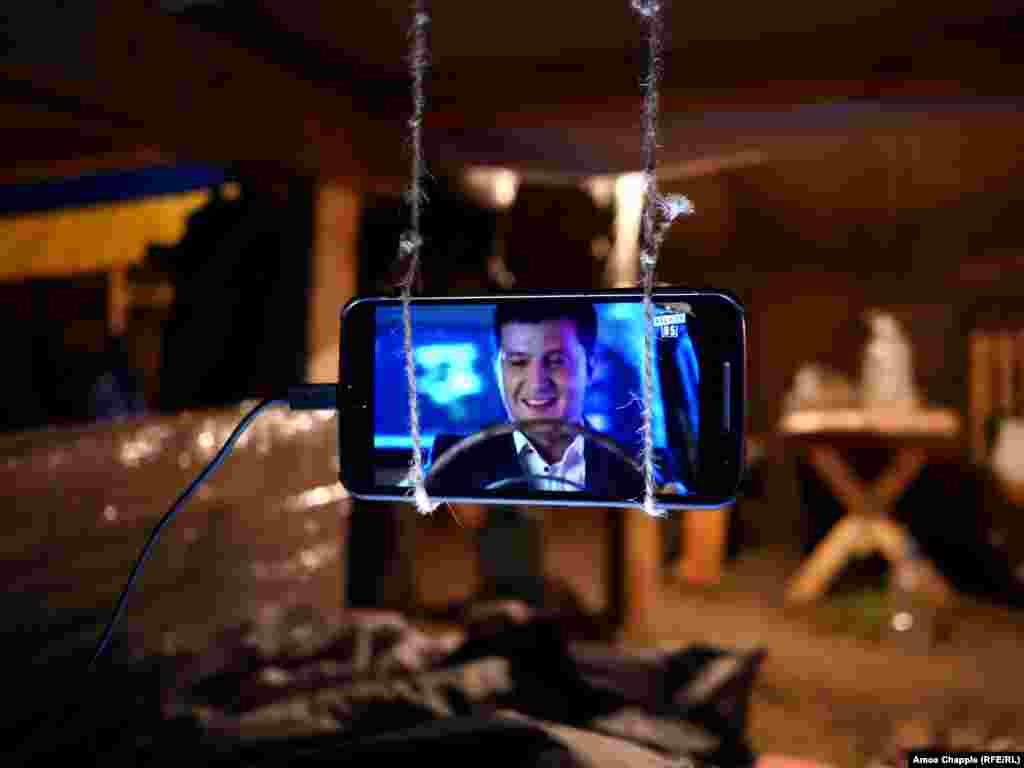 Inside the main sleeping tent, looped strings to hang cellphones on dangle above the beds. Distant explosions from the war zone echo through the camp, and lights stay on through the night “for security reasons."