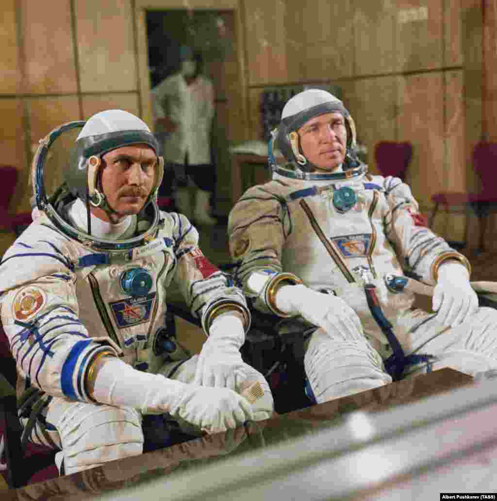 Cosmonauts Anatoly Berezovoy and Valentin Lebedev speak to the media behind glass before a launch in 1982. Several Soviet prelaunch traditions continue today, including sitting together for a screening of the 1970 film The White Sun Of The Desert and urinating on the back wheel of the bus that transports space travelers to the launchpad. Female cosmonauts and astronauts reportedly bring along a small vial of urine for the ritual tire splash. 